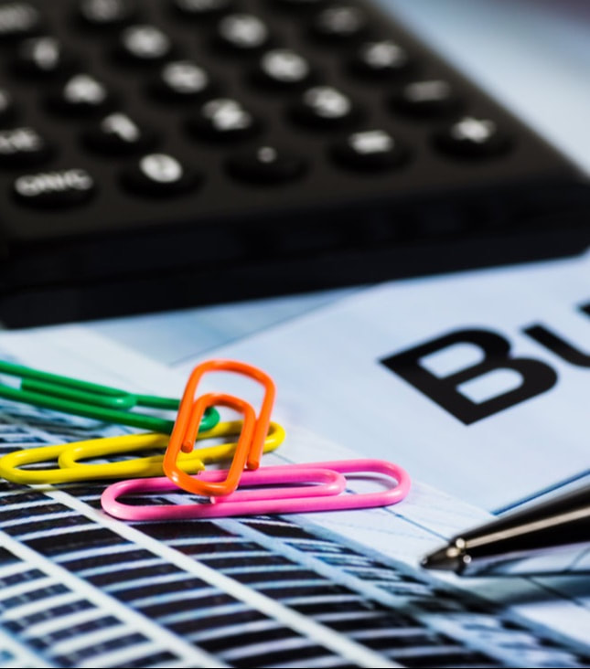 Colourful Image of Bookkeeping tools, a calculator and paperclips